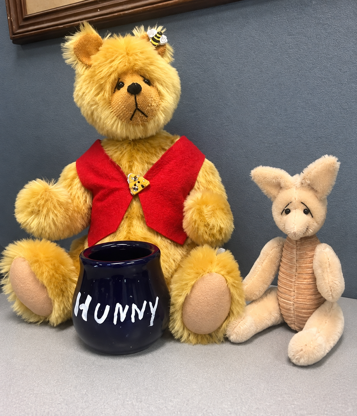 Handmade yellow bear and small companion beside a honey pot