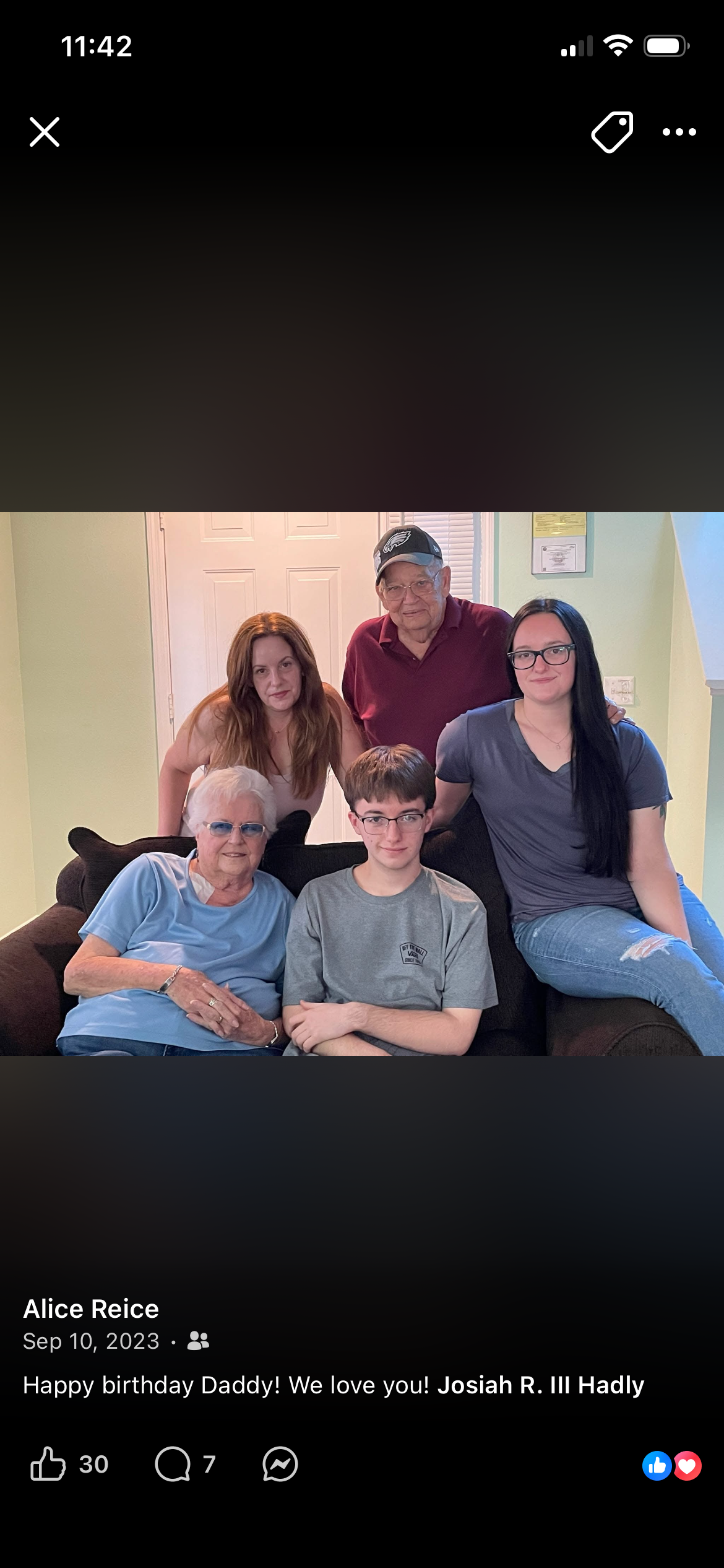 Jay and his wife surrounded by family